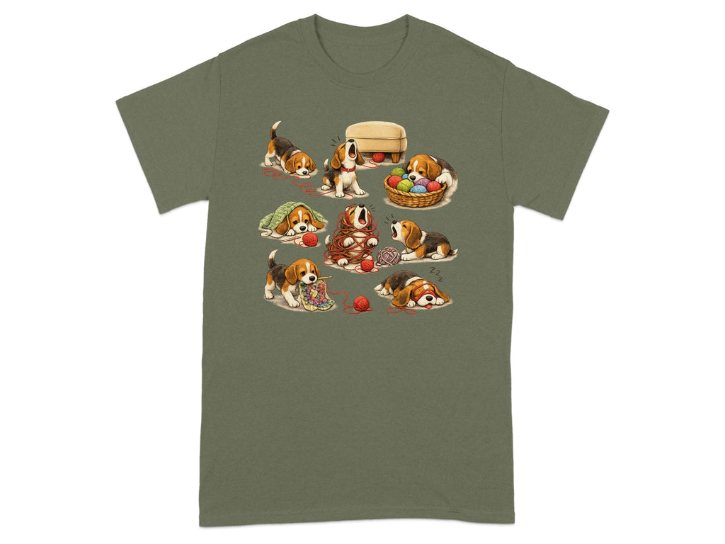 Beagle puppies tangled in yarn and playing with knitting supplies on a green t-shirt.
