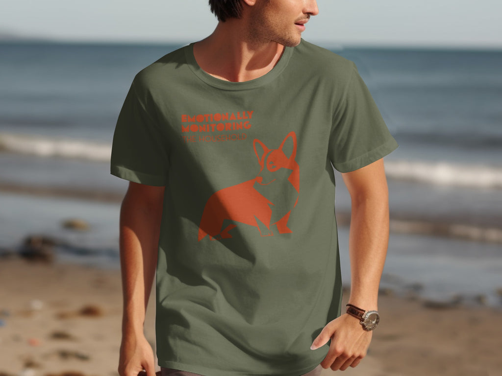 Olive green t-shirt with orange corgi graphic and text "Emotionally Monitoring".