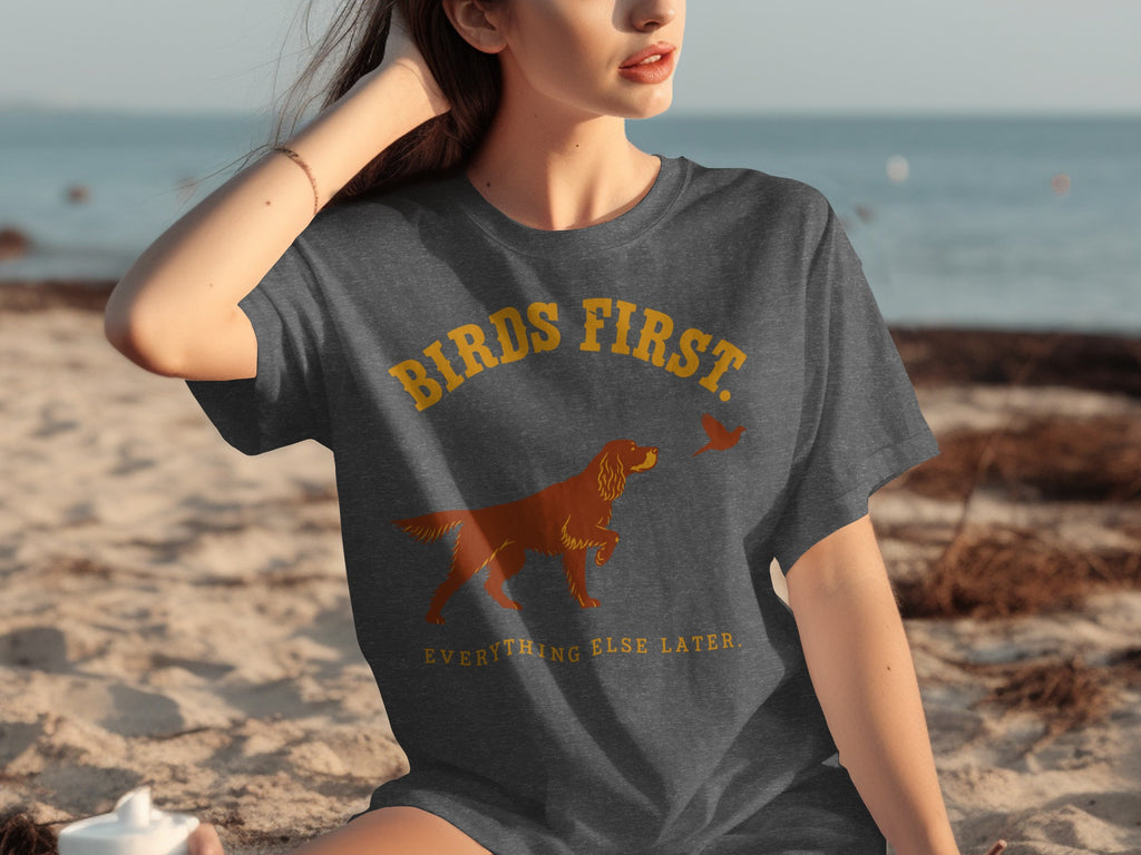 Dark grey t-shirt with "BIRDS FIRST EVERYTHING ELSE LATER" and dog and bird graphic.