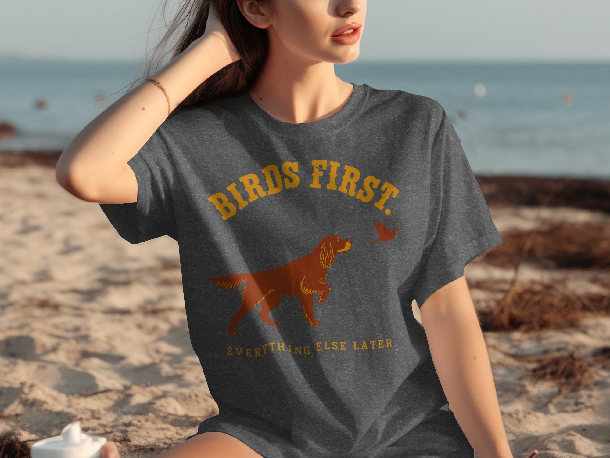 Dark grey t-shirt with "BIRDS FIRST EVERYTHING ELSE LATER" and dog and bird graphic.