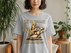 Grey t-shirt with a corgi riding a winged goose, text reads "Off to commit Shenanigans".