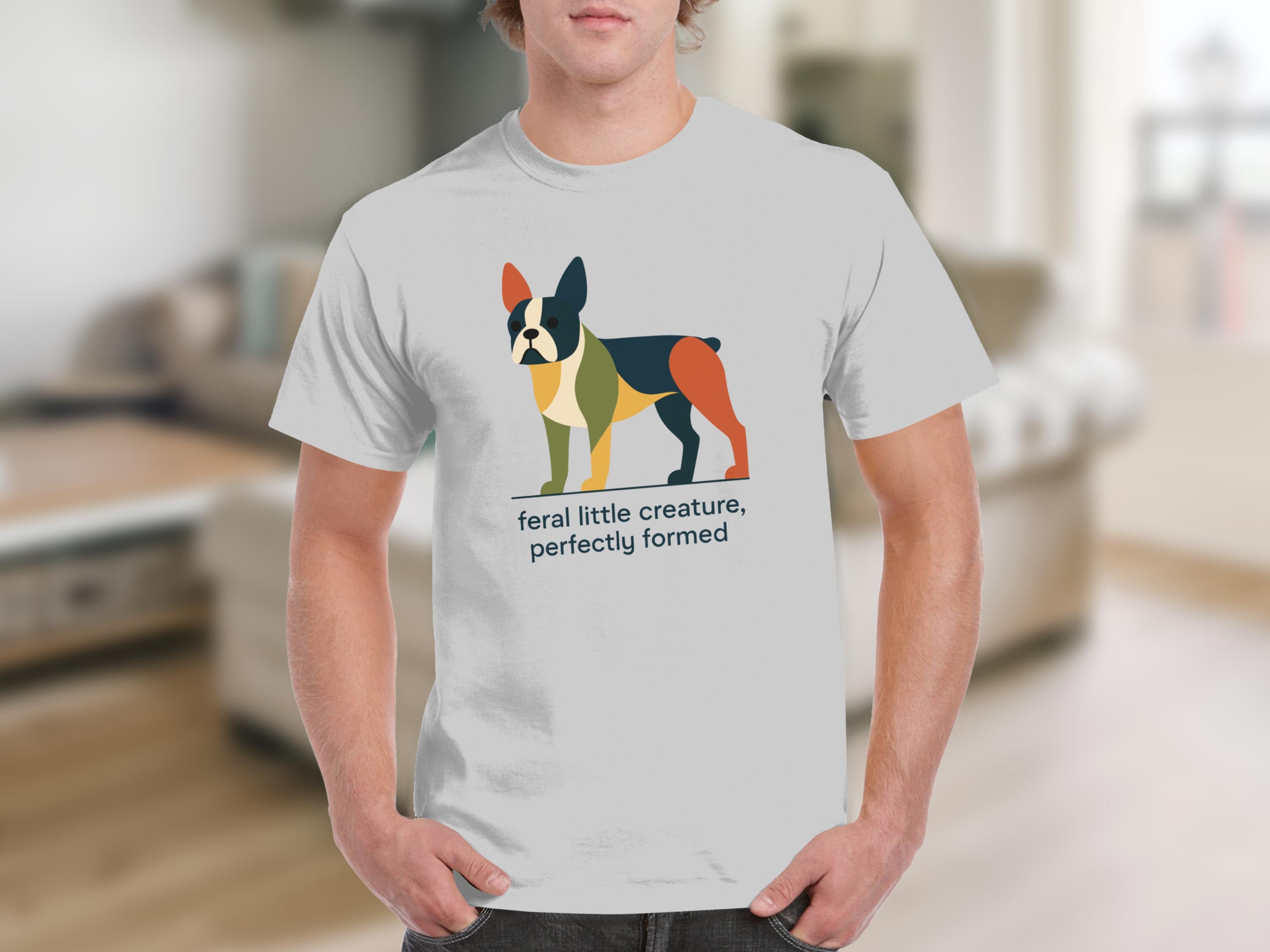 White t-shirt with a colorful abstract Boston Terrier and the text "feral little creature, perfectly formed".