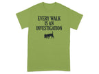 Green t-shirt with "EVERY WALK IS AN INVESTIGATION" and a dog sniffing.