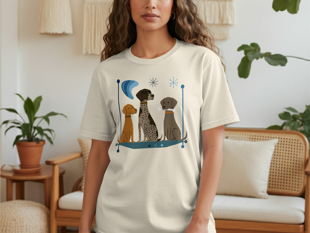 T-shirt with three dogs sitting in a stylized blue border.