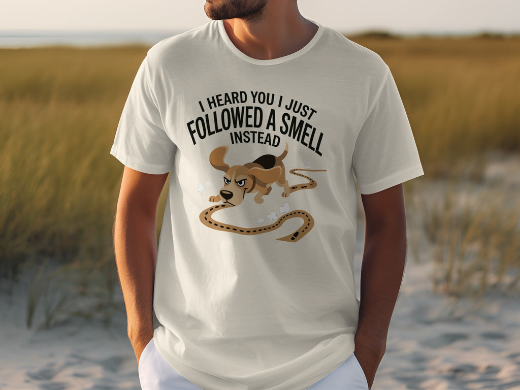 White t-shirt with "I HEARD YOU I JUST FOLLOWED A SMELL INSTEAD" and cartoon dog graphic.