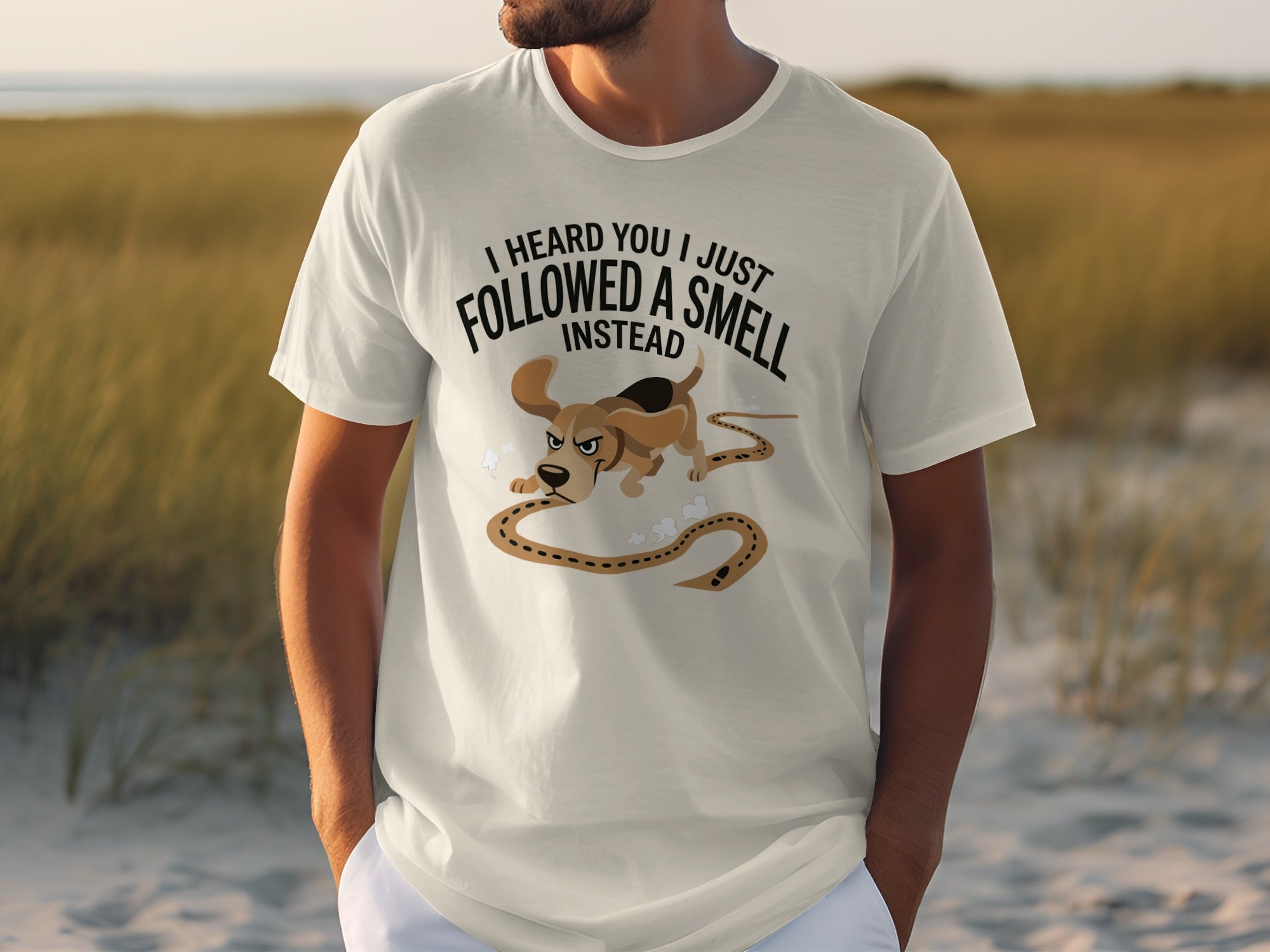 White t-shirt with "I HEARD YOU I JUST FOLLOWED A SMELL INSTEAD" and cartoon dog graphic.