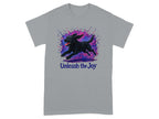 Grey t-shirt with a black dog mid-leap surrounded by colorful paint splatters and the text "Unleash the Joy".