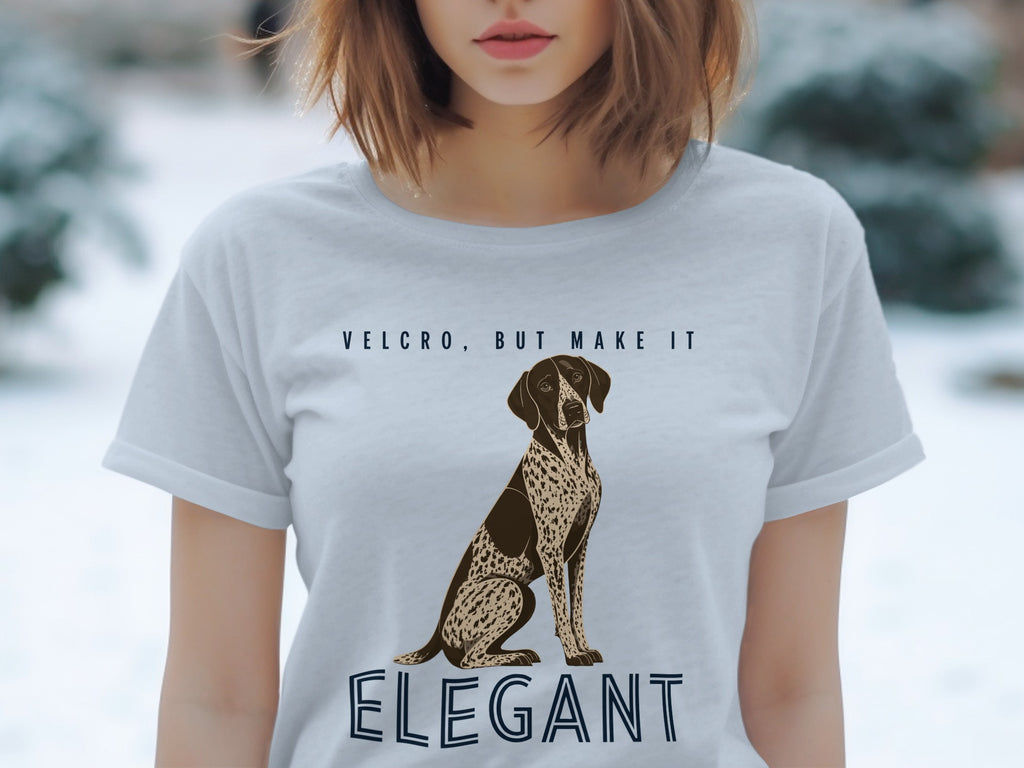 Light grey t-shirt with a brown and white dog and text "Velcro, but make it Elegant".
