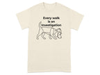 Cream t-shirt with a line drawing of a beagle wearing a detective hat, text "Every walk is an Investigation".