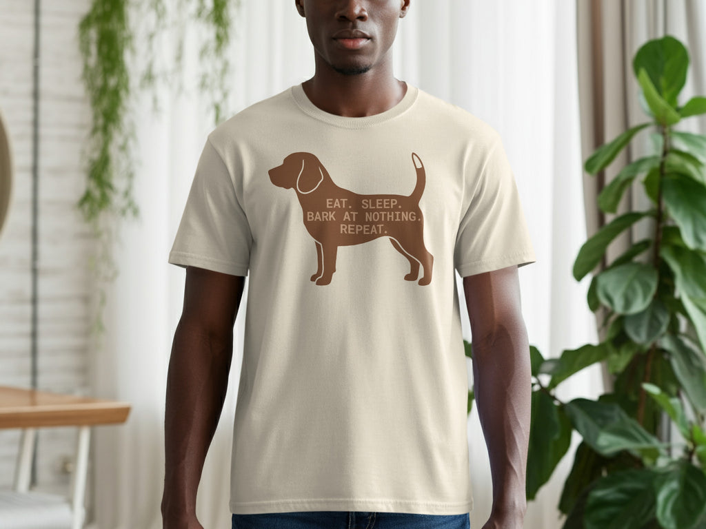 Dog silhouette with text "EAT. SLEEP. BARK AT NOTHING." on a beige t-shirt.