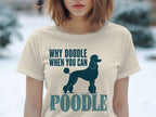 Cream t-shirt with dark blue poodle silhouette and text "WHY DOODLE WHEN YOU CAN POODLE".