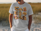 T-shirt with cartoon golden retrievers interacting with books, some reading, some playing.