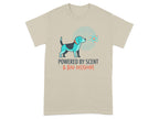 Beige t-shirt with dog graphic and text "POWERED BY SCENT & BAD DECISIONS".