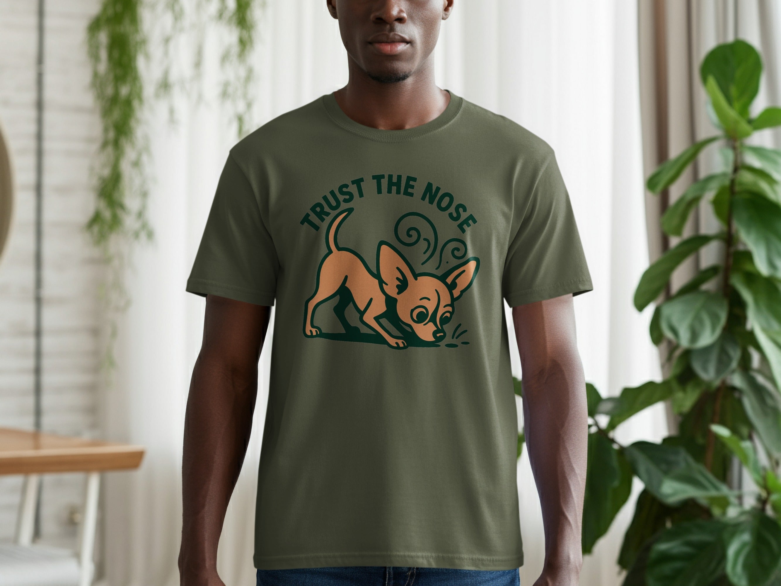 Olive green t-shirt with cartoon dog and "TRUST THE NOSE" text.