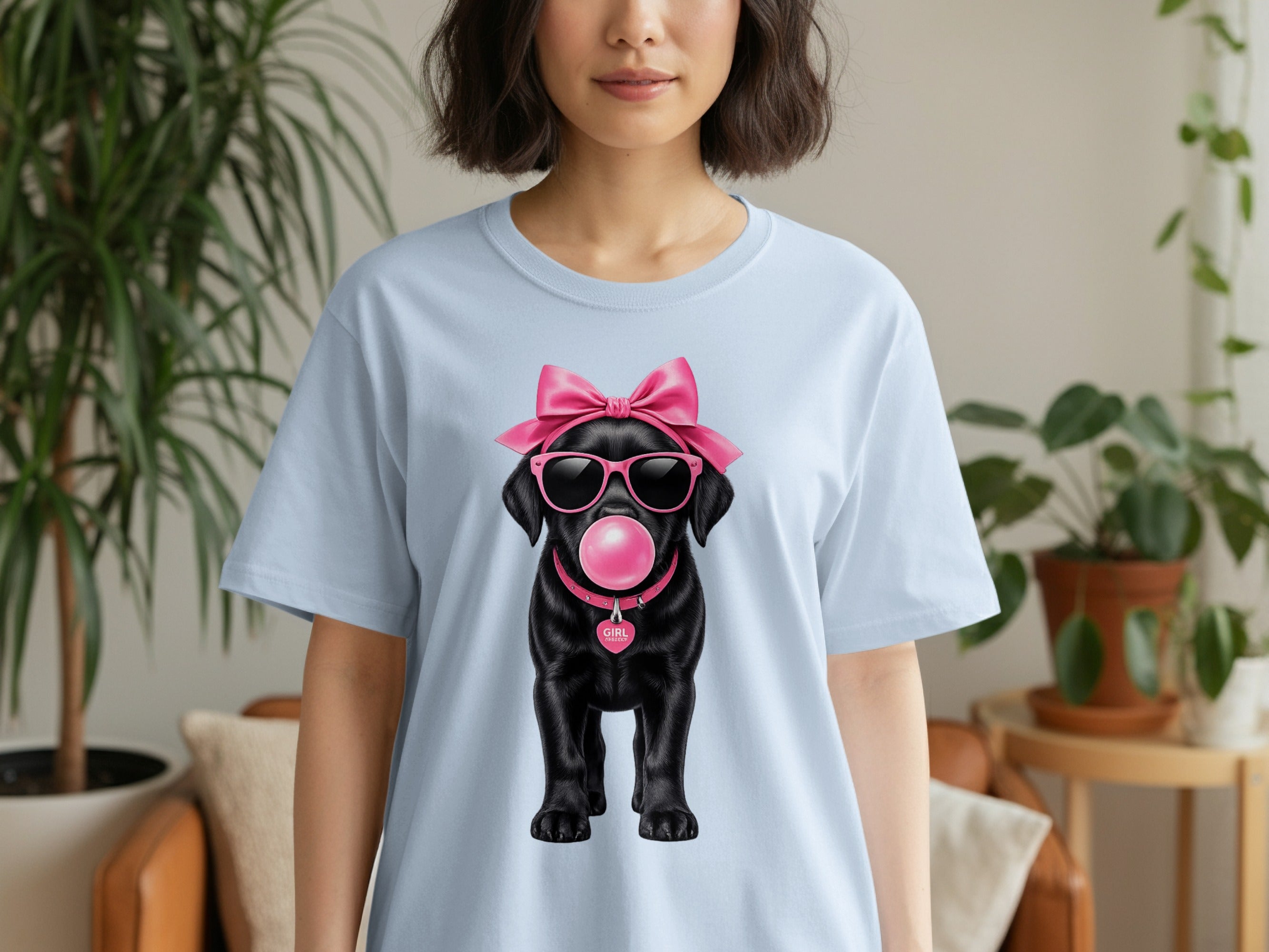Light blue t-shirt with a black dog wearing pink bow, sunglasses, blowing bubble gum.