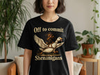 Black t-shirt with text "Off to commit Shenanigans" and a dachshund riding a flying goose.