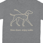 Grey t-shirt with line drawing of a dog on a leash and the text "Slow down, enjoy walks".