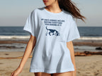 Light blue t-shirt with dog graphic and "My dog's hobbies include: sniffing everything then barking at it."