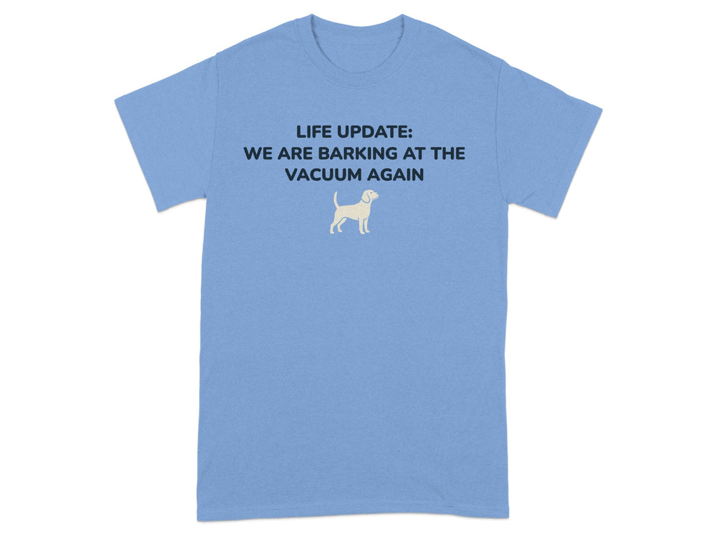 Blue t-shirt with white text: "LIFE UPDATE: WE ARE BARKING AT THE VACUUM AGAIN" and a dog silhouette.