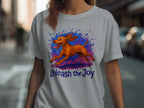 Gray t-shirt with a running brown dog and "Unleash the Joy" text design.