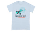 Light blue t-shirt with a dog and atom graphic and text "POWERED BY SCENT & BAD DECISIONS".