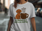 Brown Vizsla dog sitting by a coffee mug with text "Powered by Vizsla & Coffee".