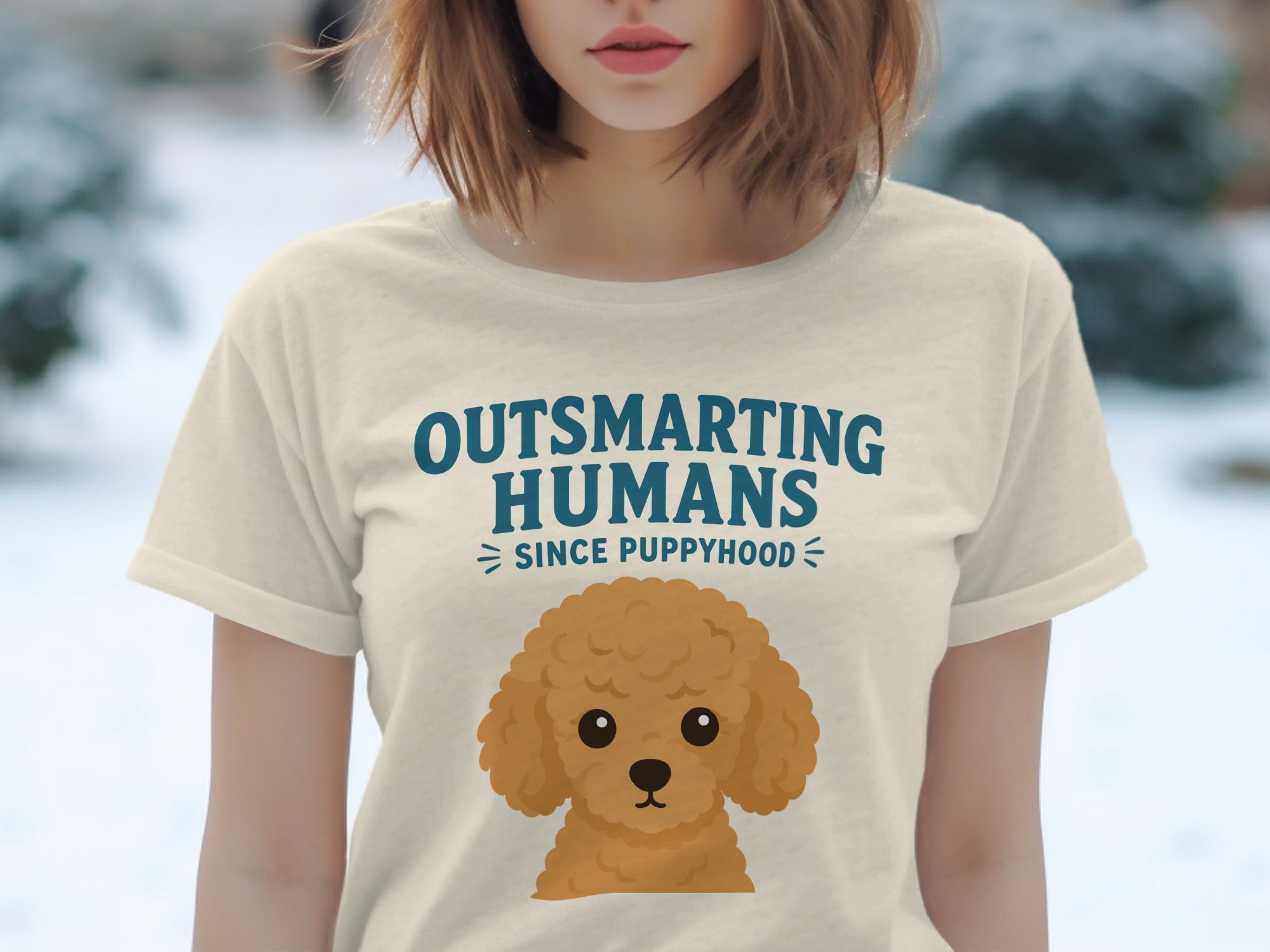 Cream t-shirt with "Outsmarting Humans Since Puppyhood" and a poodle illustration.