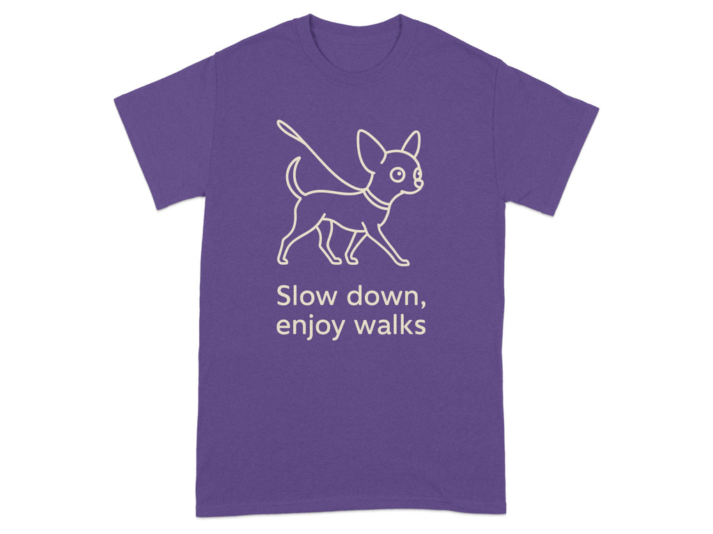 Purple t-shirt with white line drawing of a dog and text "Slow down, enjoy walks".
