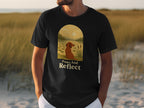 Black t-shirt with a dog and landscape scene, text reads "Paws And Reflect".