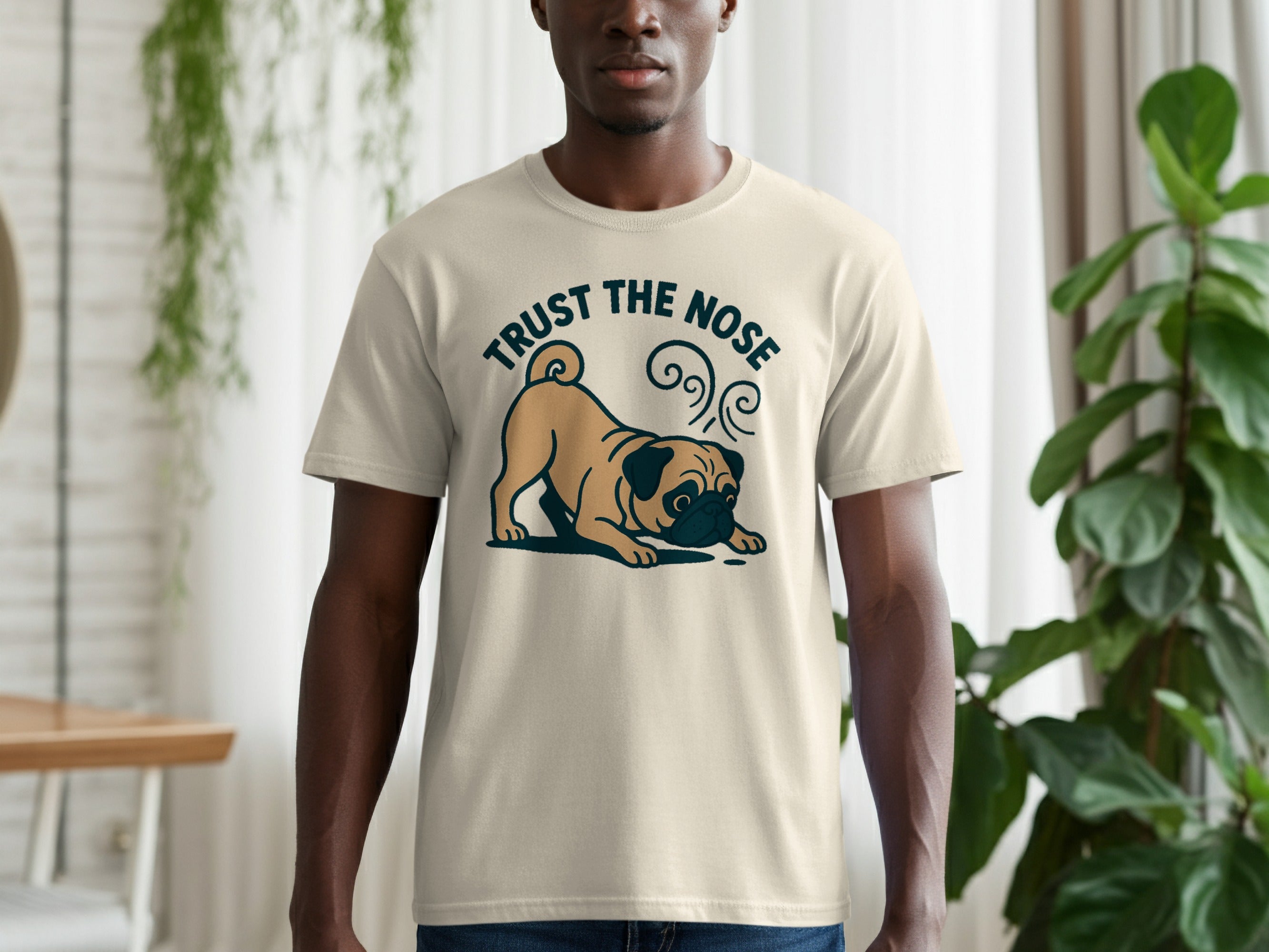 Cream t-shirt with a pug graphic and the text "TRUST THE NOSE".