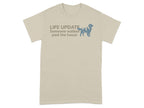 Tan t-shirt with text "LIFE UPDATE Someone walked past the house" and dog silhouette.