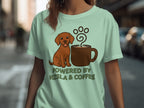 Dog sitting next to a coffee mug with text "POWERED BY VIZSLA & COFFEE".