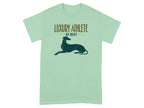 Light mint t-shirt with a greyhound and "LUXURY ATHLETE AT REST" text.