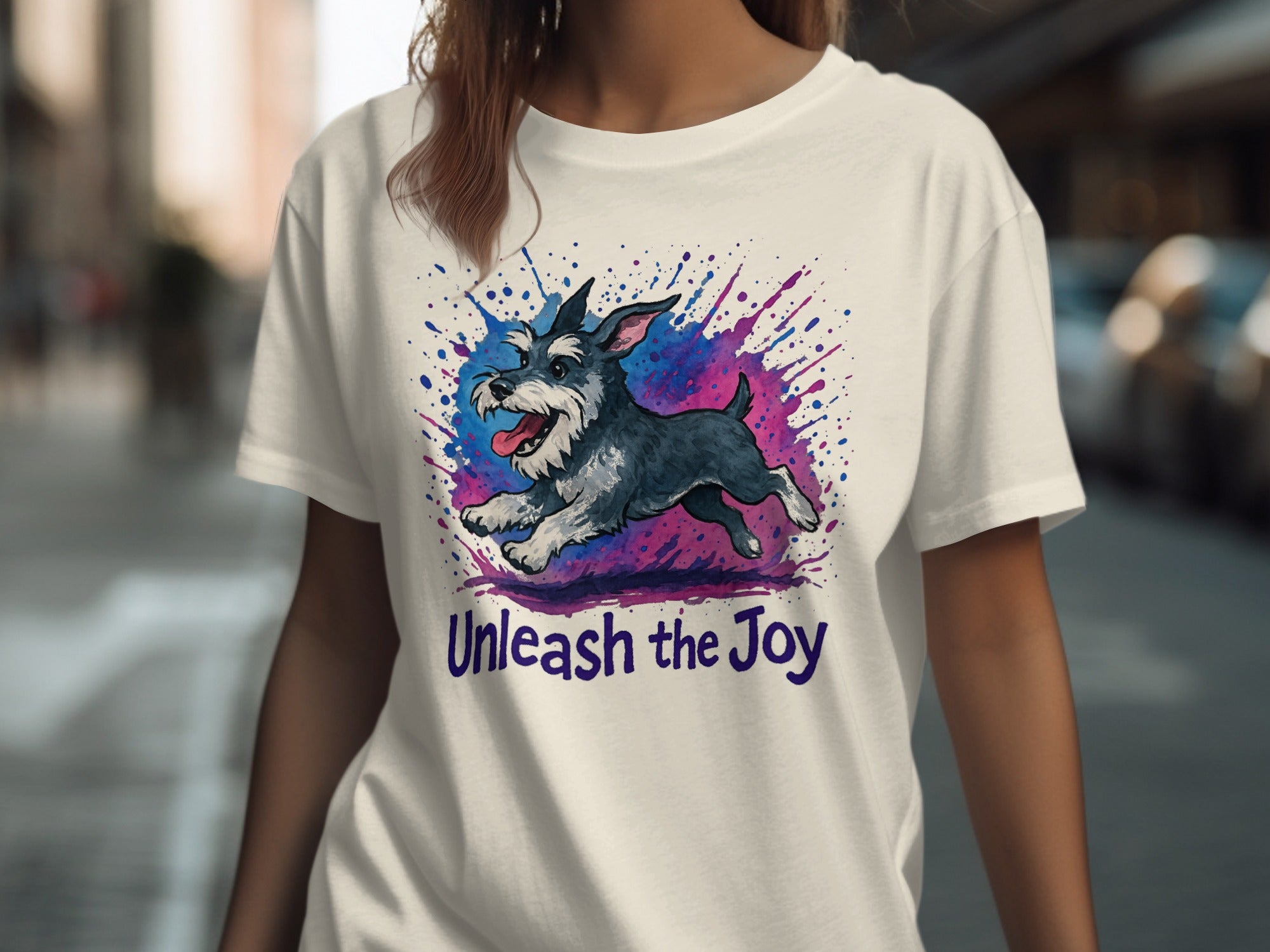 White t-shirt with watercolor schnauzer graphic and "Unleash the Joy" text.