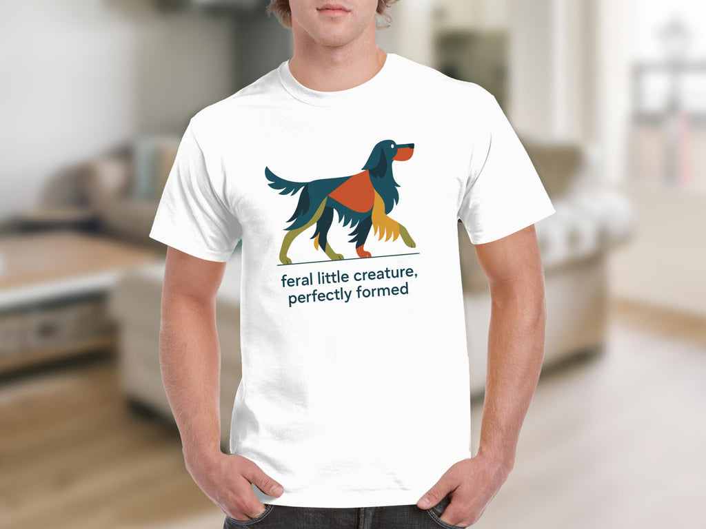 White t-shirt with abstract dog graphic and text "feral little creature, perfectly formed".