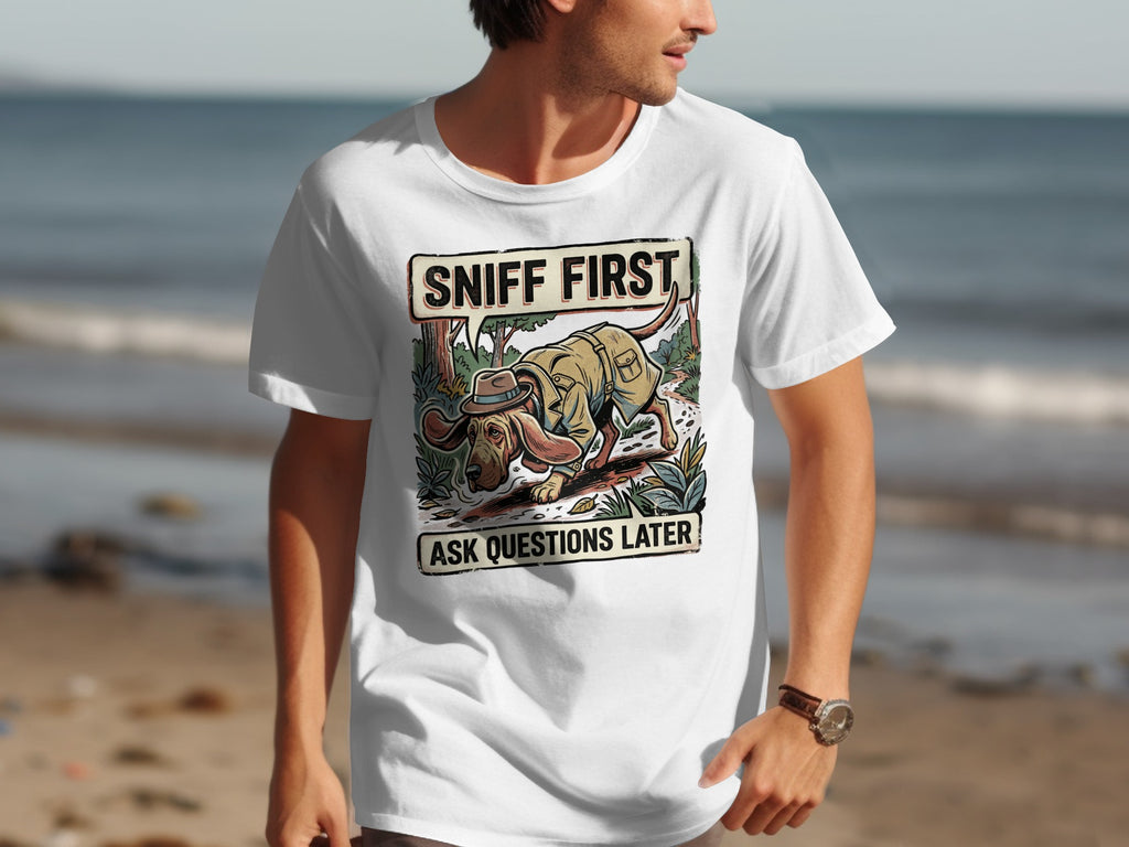 White t-shirt with "SNIFF FIRST ASK QUESTIONS LATER" graphic featuring a cartoon dog.