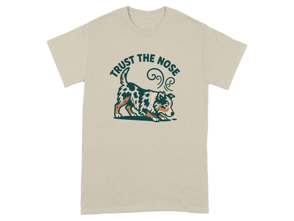 Beige t-shirt featuring a dog sniffing the ground with text "TRUST THE NOSE".