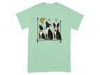 Three Boston terriers with geometric accents on a light green t-shirt.