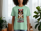 Light green t-shirt with a dog wearing sunglasses and a pink bow, saying "First of all, I'm a delight".