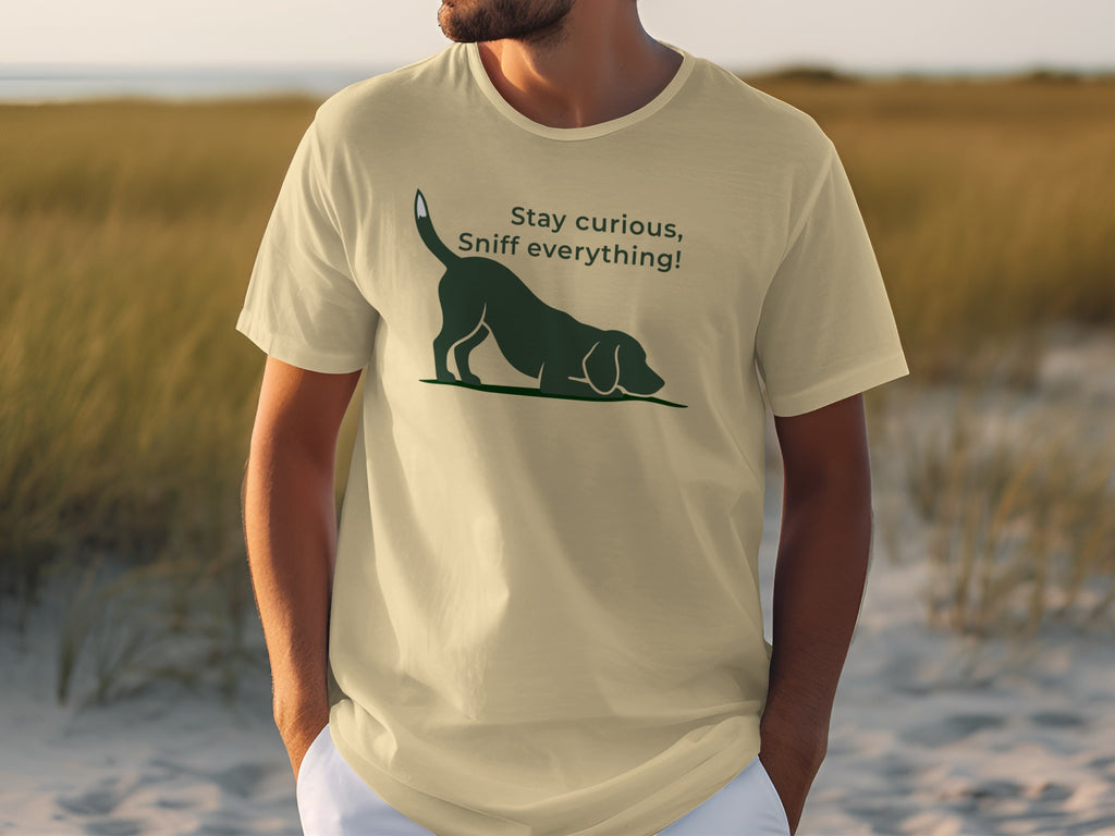 Light beige t-shirt with a black dog illustration and "Stay Curious, Sniff Everything!" text.