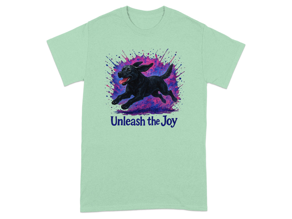 Mint t-shirt with black lab running through colorful paint splashes and text "Unleash the Joy."