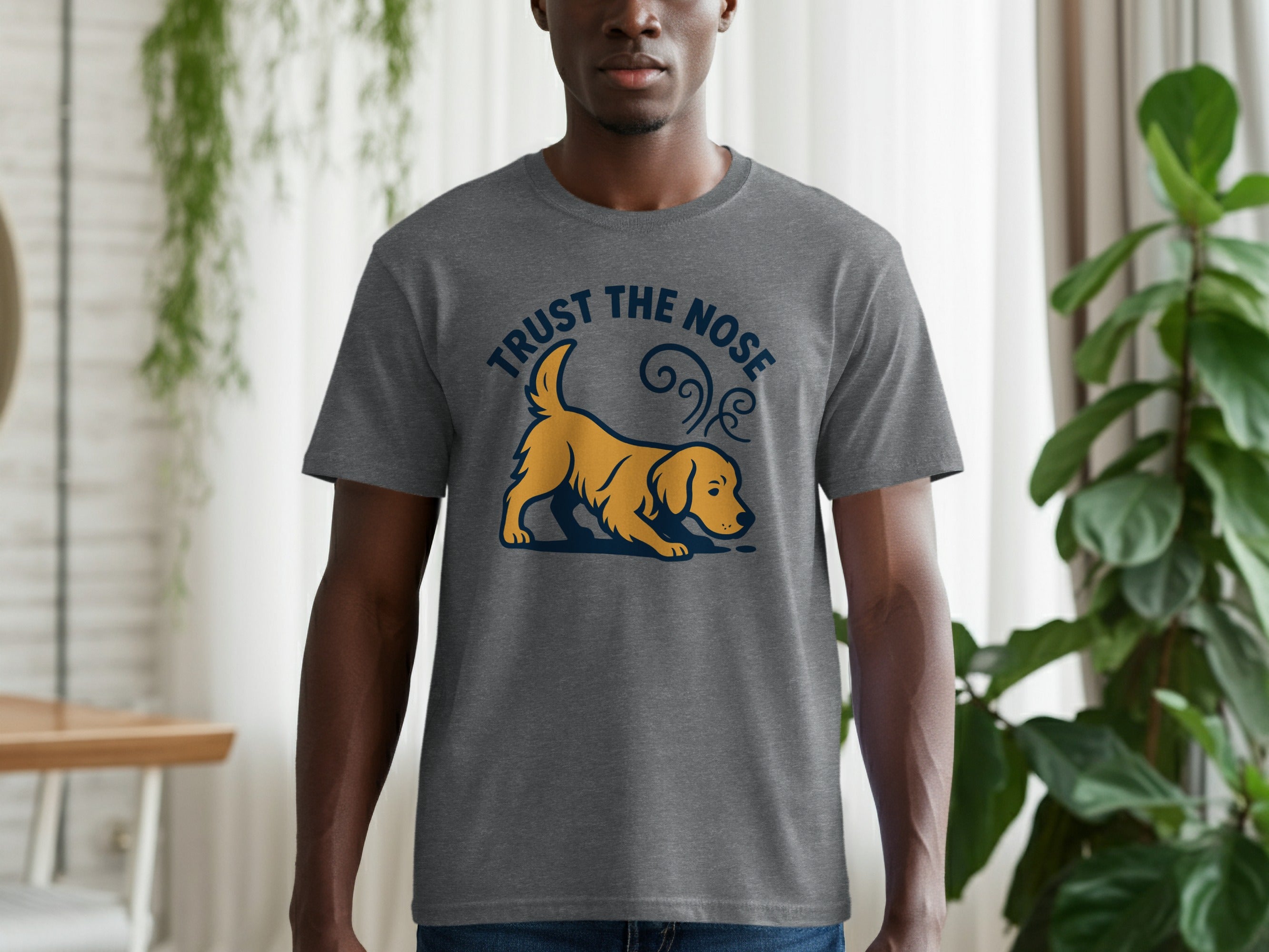 Dark gray t-shirt with a yellow dog graphic and text "TRUST THE NOSE"