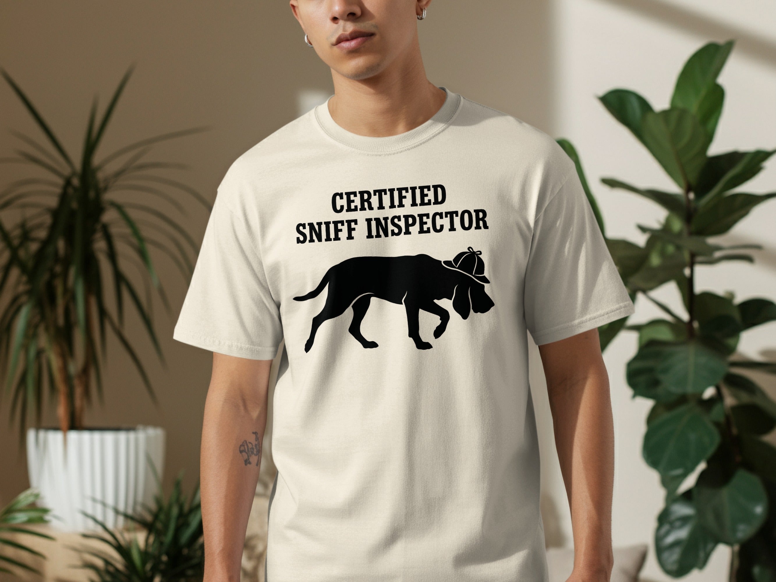 Cream t-shirt with black graphic of a dog wearing a hat and text "CERTIFIED SNIFF INSPECTOR".