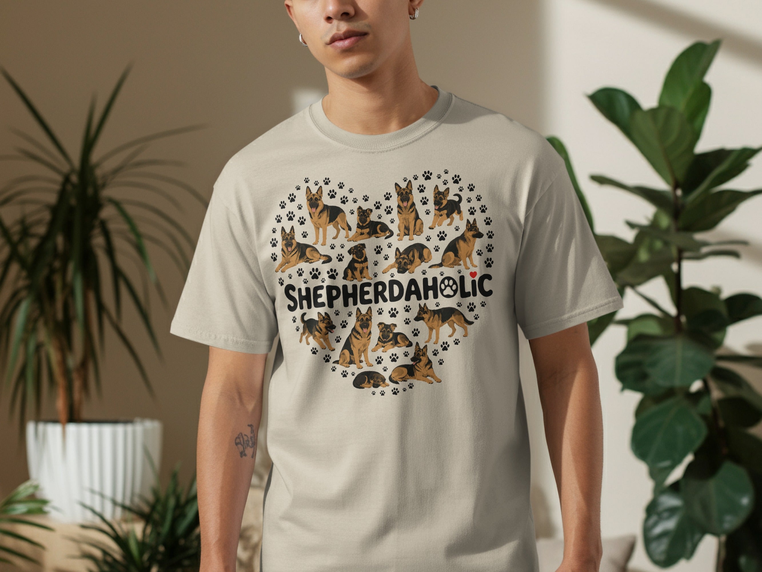 Heart-shaped design of German Shepherds and paw prints on a light tan t-shirt.