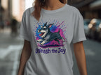 Light grey t-shirt with a running schnauzer illustration and the text "Unleash the Joy".