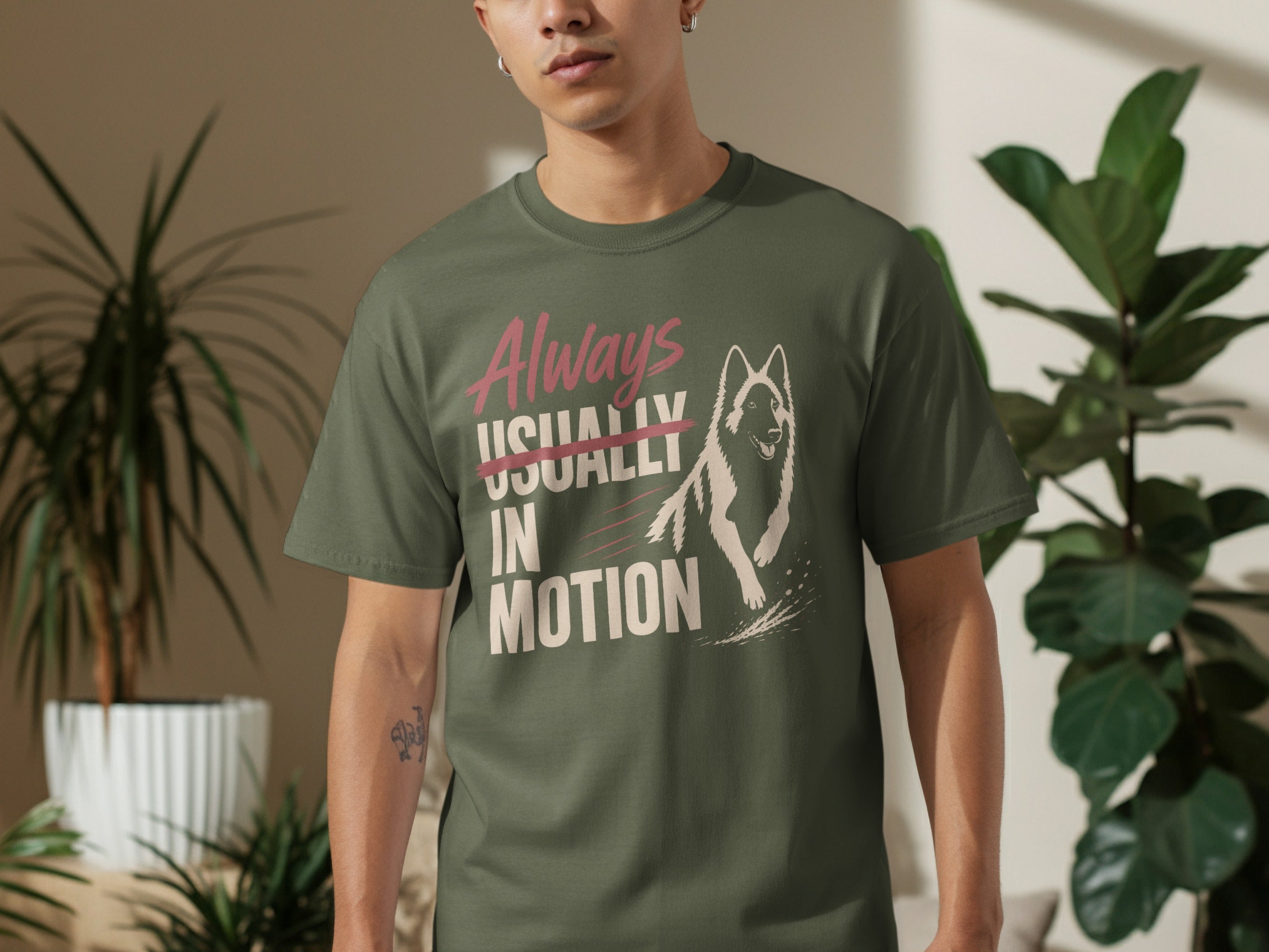 Green t-shirt with "Always Usually In Motion" text and wolf graphic.