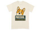Corgi peeking over "PROCESSING... PLEASE WAIT" sign on a t-shirt.