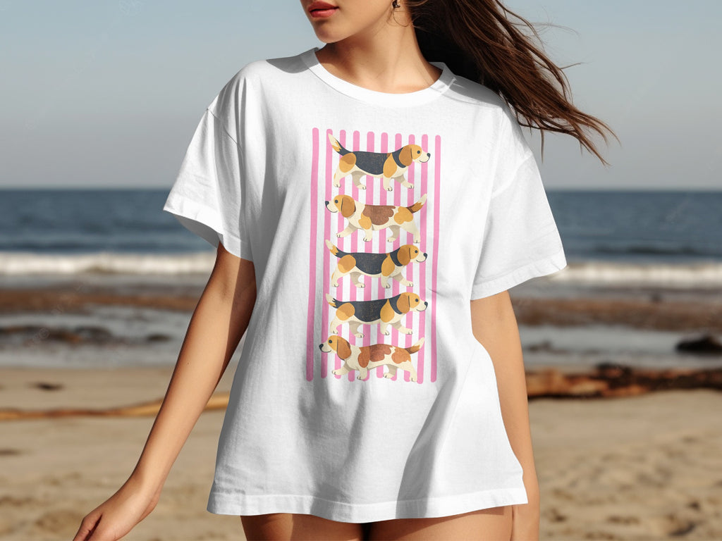 White t-shirt with a graphic of three beagles stacked vertically on pink stripes.