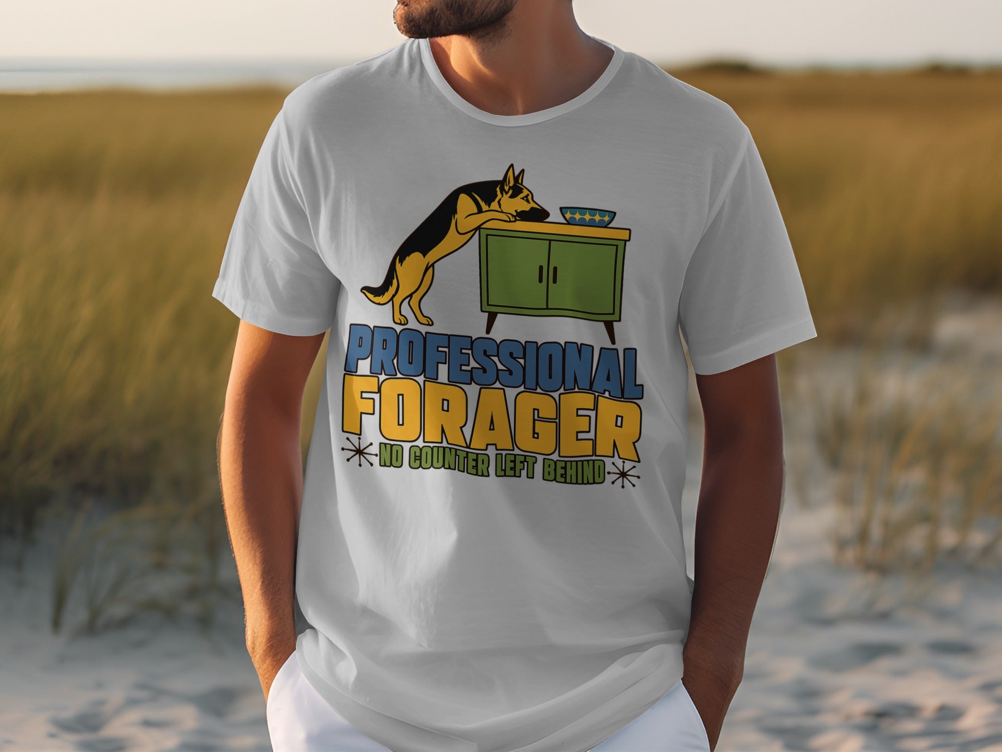 White t-shirt with "Professional Forager" text and a dog near a cabinet.