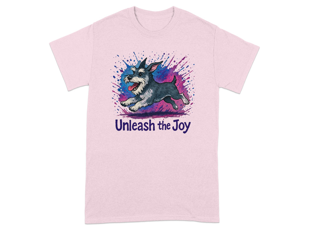 Pink t-shirt with a happy schnauzer jumping with watercolor splatter and "Unleash the Joy" text.
